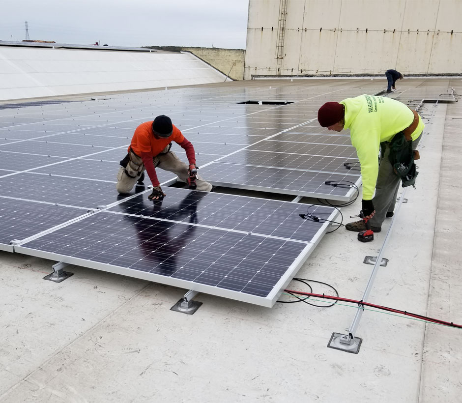 Workers installing solar panels